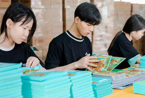 3 workers checkin on finished products on the production line
